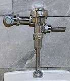 Close-up of a chrome Sloan flush valve